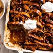 French toast bake in a baking dish drizzled with hot buttered rum