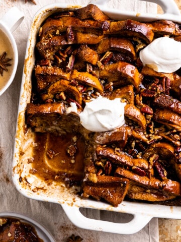 French toast bake in a baking dish drizzled with hot buttered rum