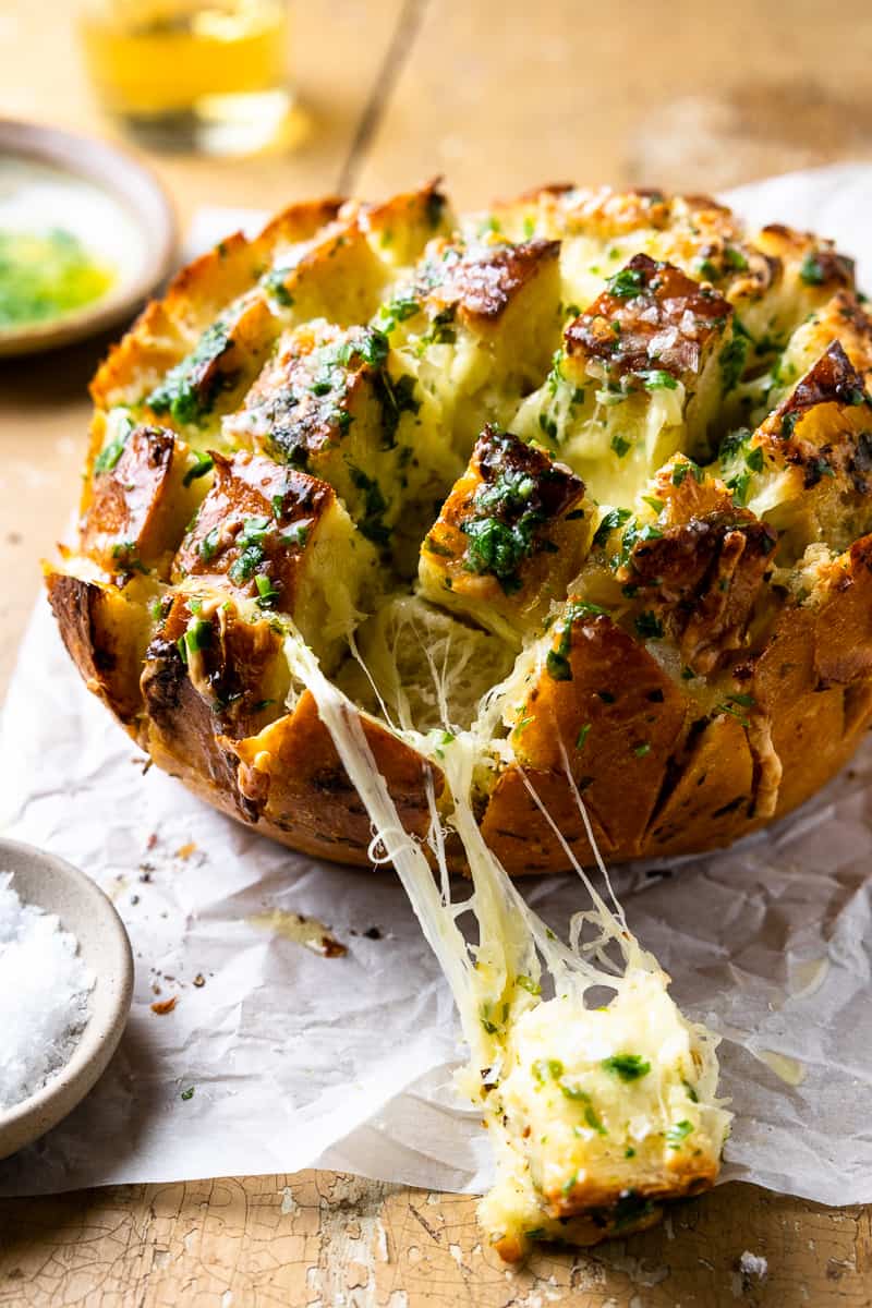 pulling apart cheesy garlic bread