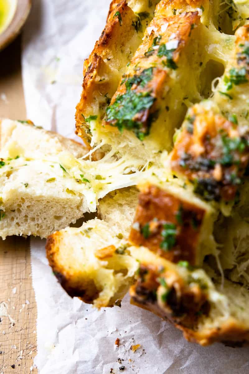 pulling apart cheesy garlic bread