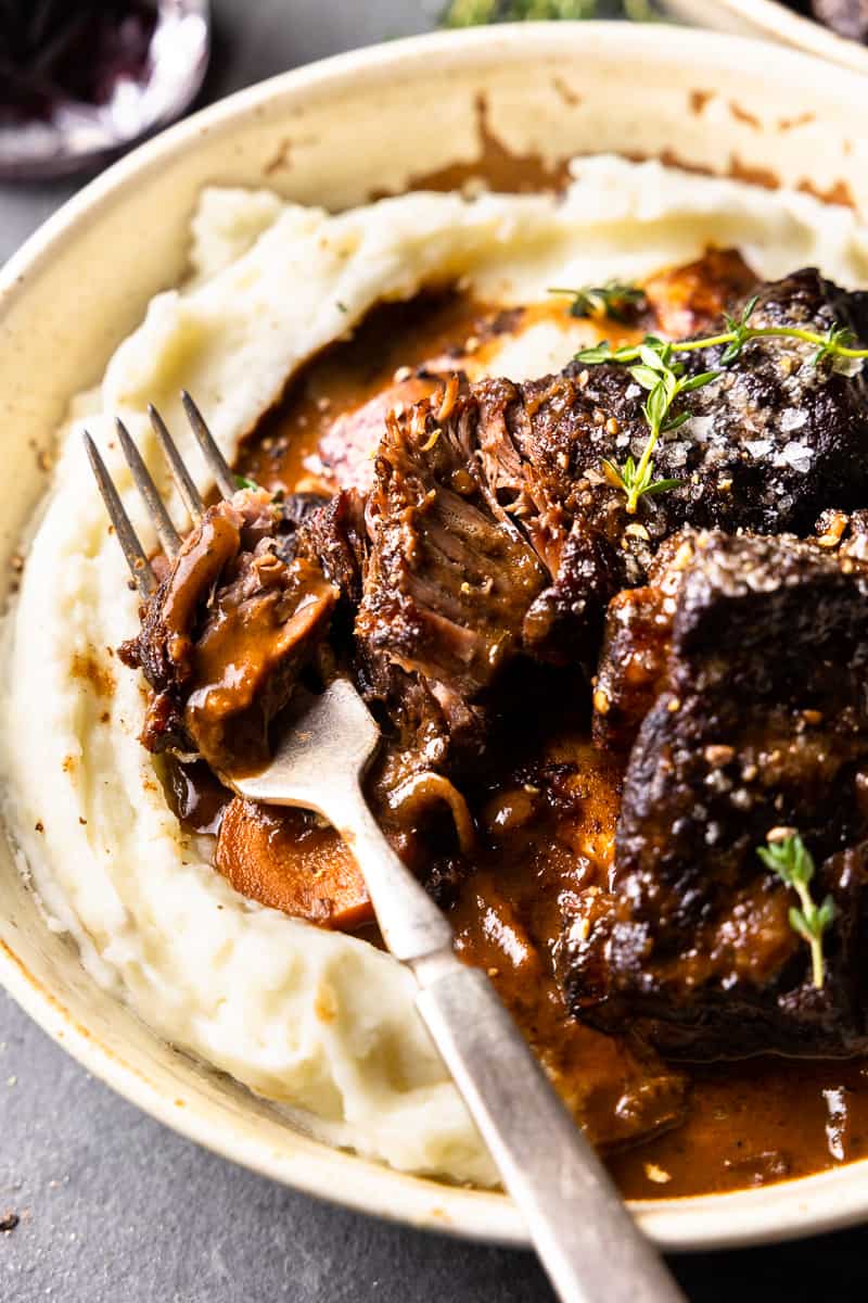 pulling apart braised bison short ribs with a fork