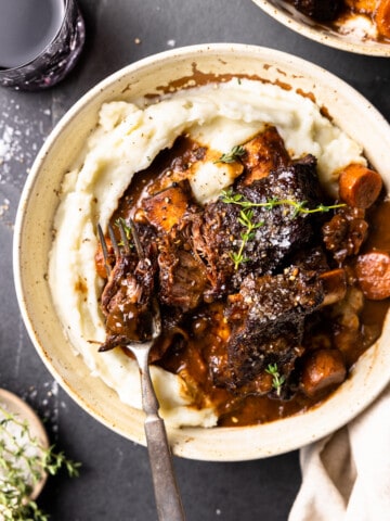 bowl of mashed potatoes and bison short ribs in a bowl