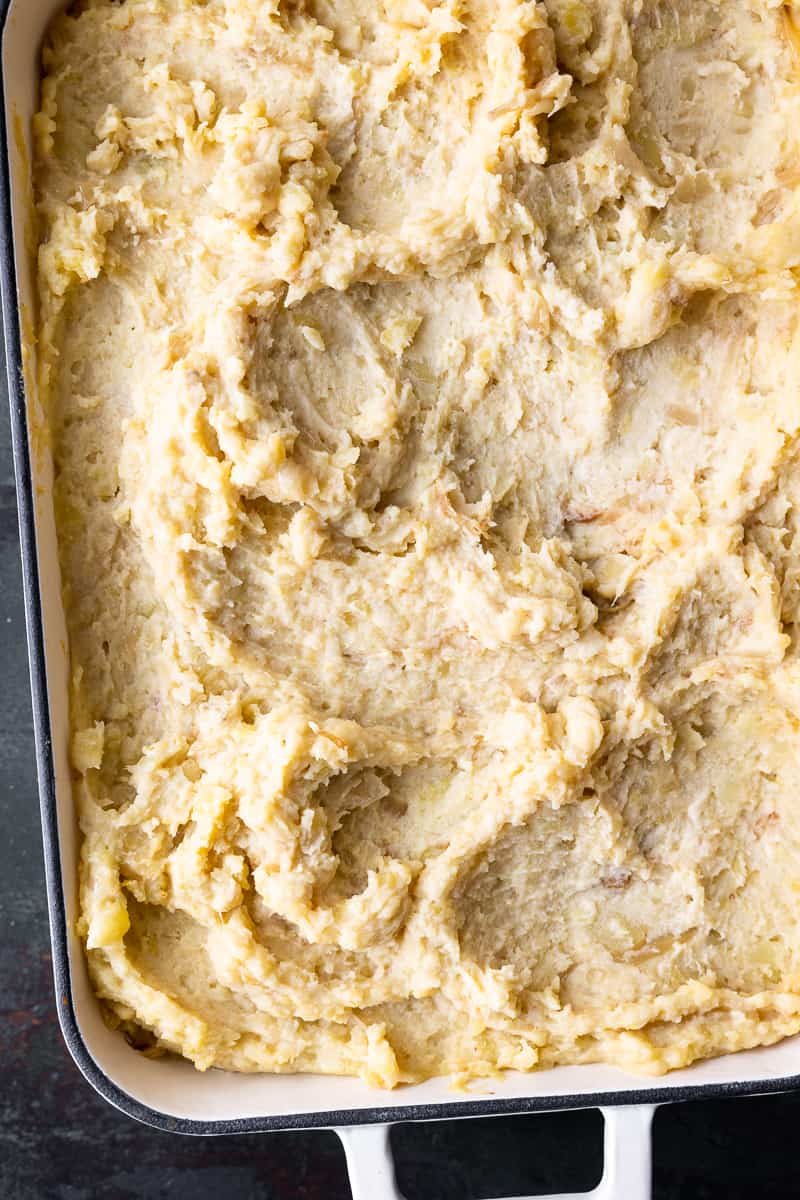 cheesy caramelized onion mashed potatoes in a baking dish