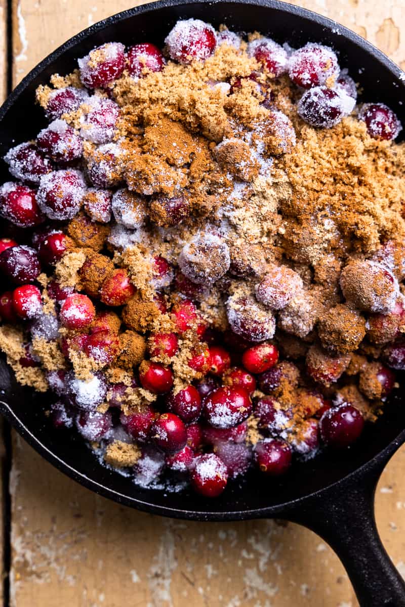 cranberries in a skillet with sugar and spices