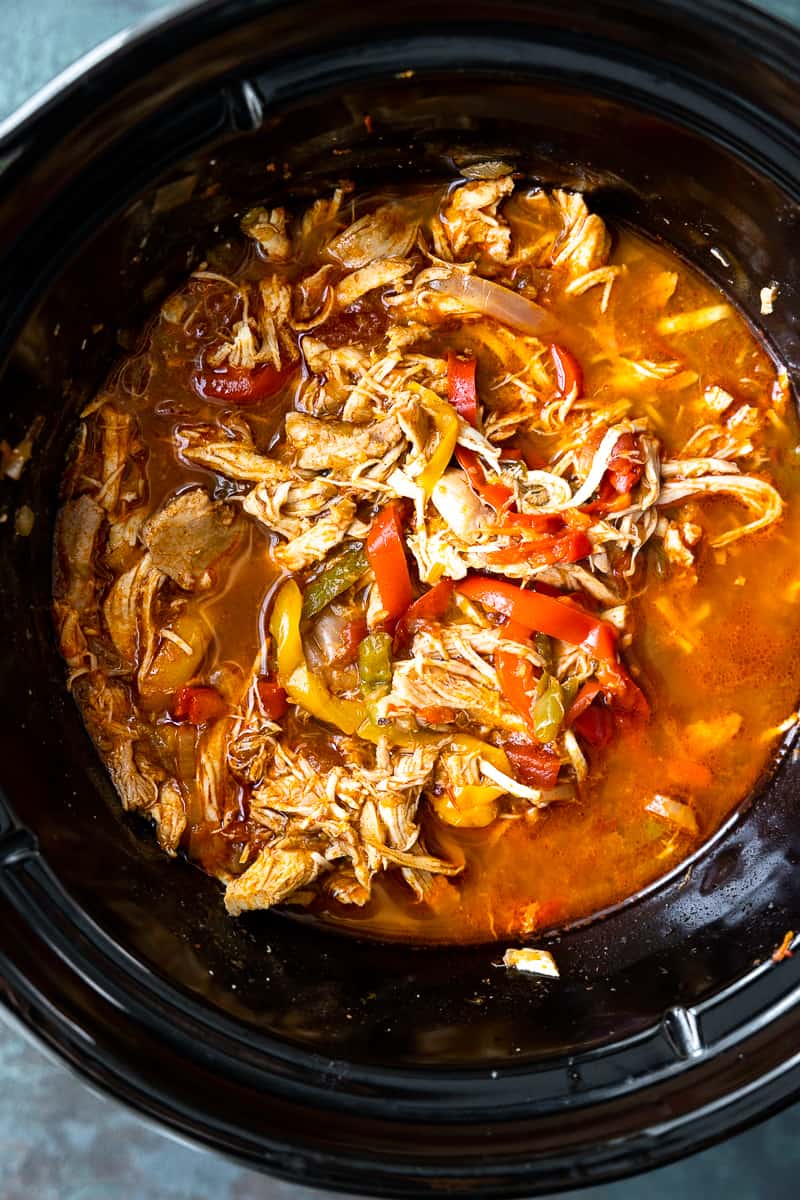 shredded chicken and fajita vegetables in a slow cooker
