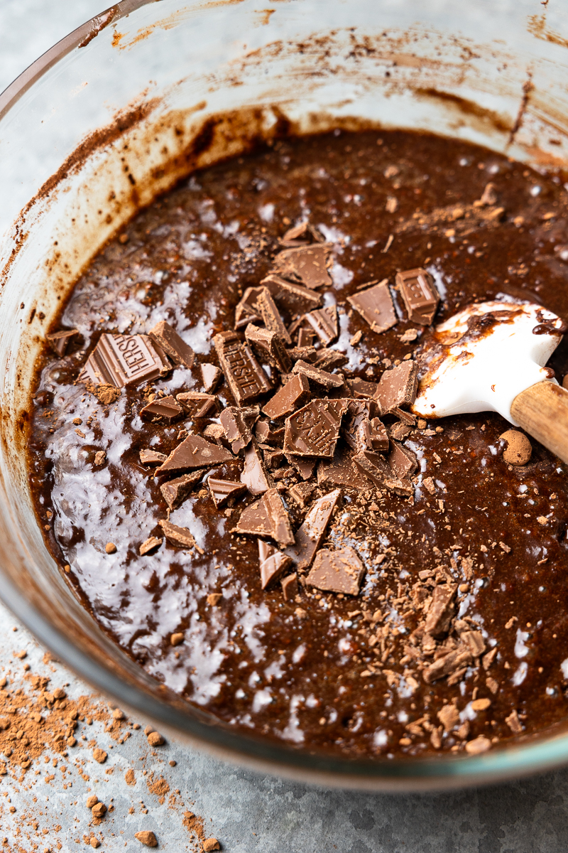 brownie batter in a bowl with chopped chocolate
