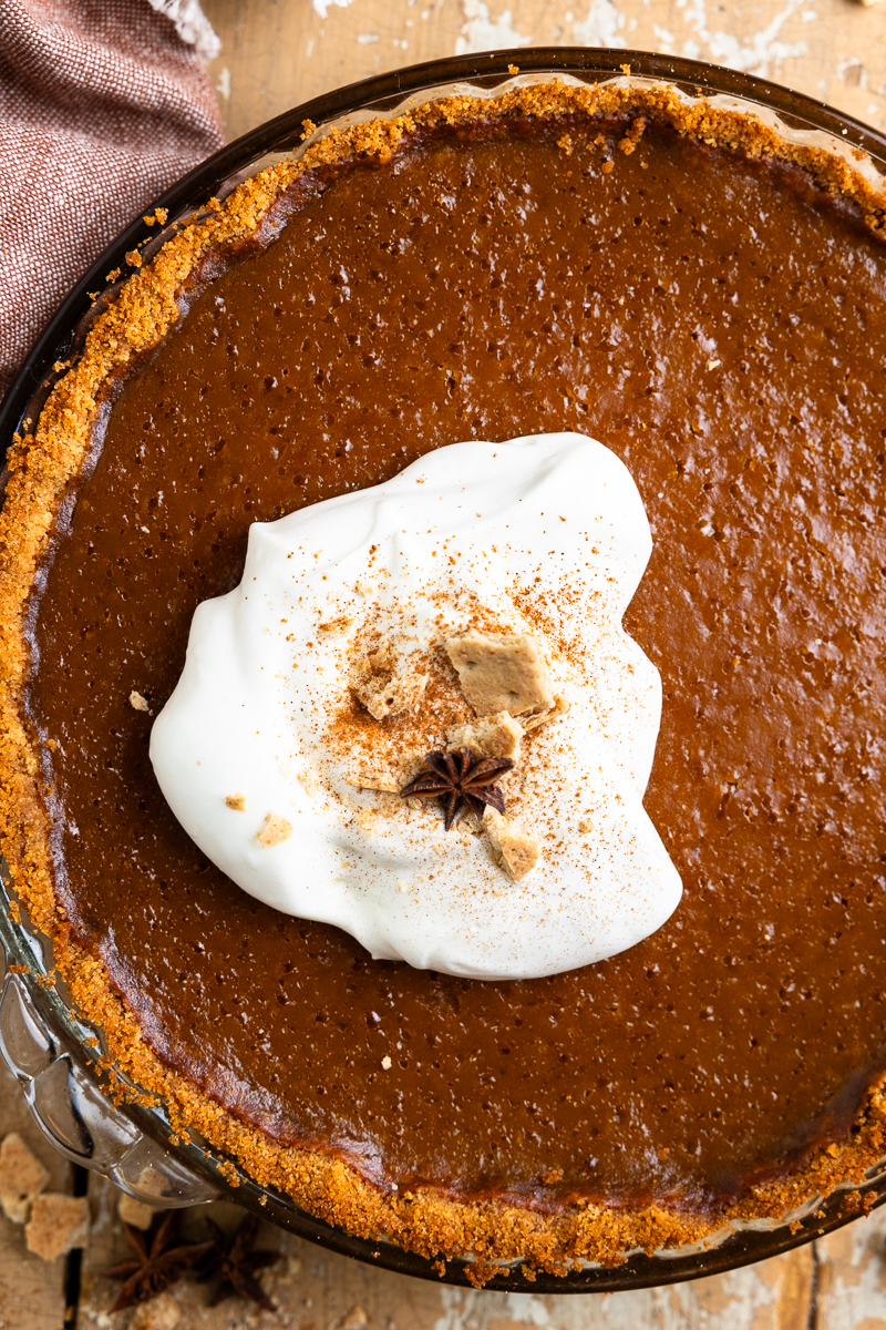 Baked pumpkin pie topped with whipped cream