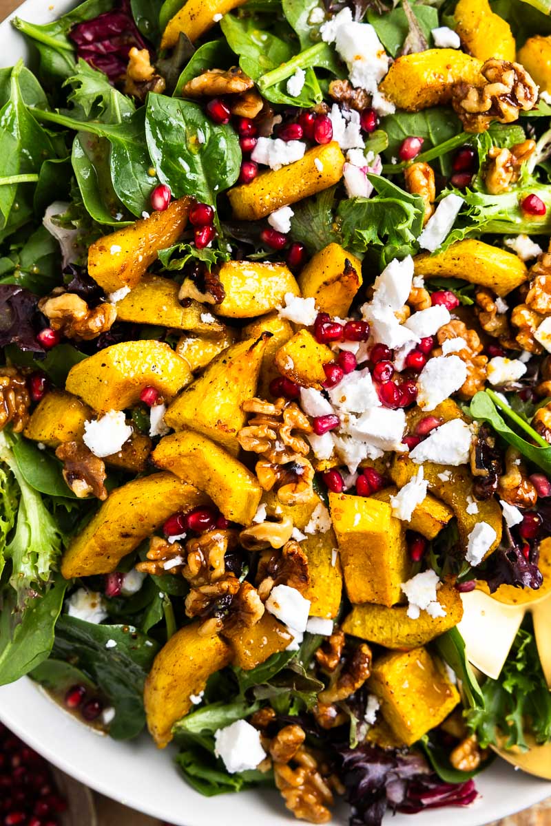 spring mix topped with roasted pumpkin, feta, walnuts, pomegranate arils and dressing