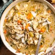 bowl of chicken and brown rice soup in a bowl and served with crusty bread