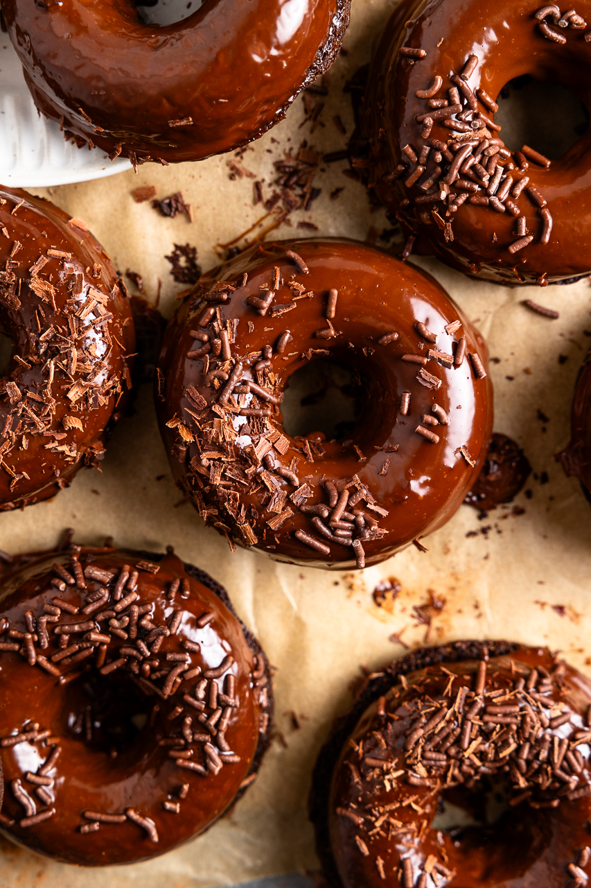 brownie donuts aka bronuts dipped in chocolate ganache and top with chocolate sprinkles
