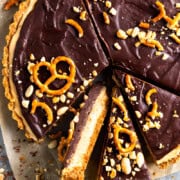 peanut butter pretzel pie cut into slices with one slice turned on its side to show layers