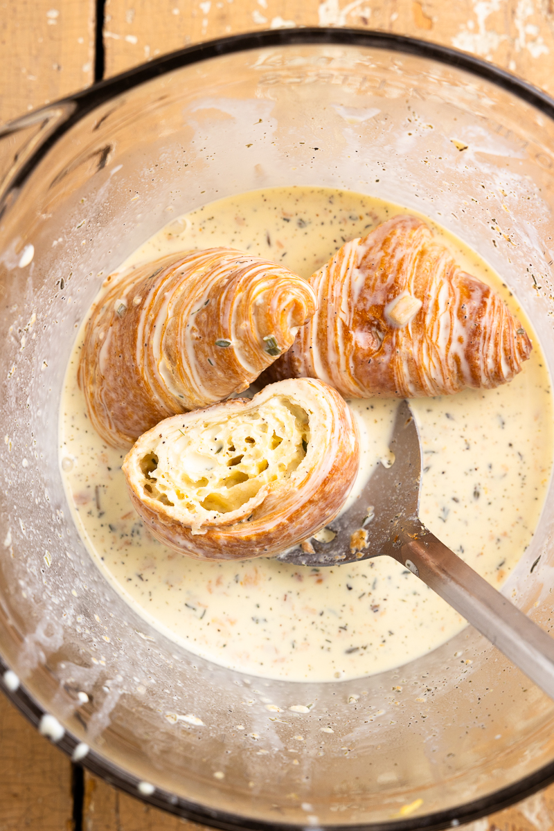 dipping croissants in an egg and cream mixture