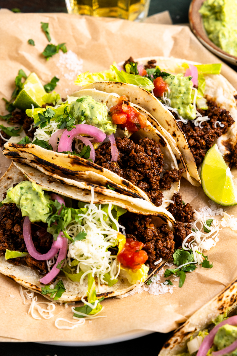 side angle of ground venison tacos on a plate