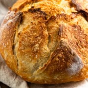 loaf of baked bread on a kitchen towel