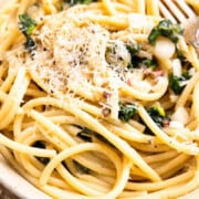 close up of ramp pasta in a bowl and garnished with parmesan and black pepper