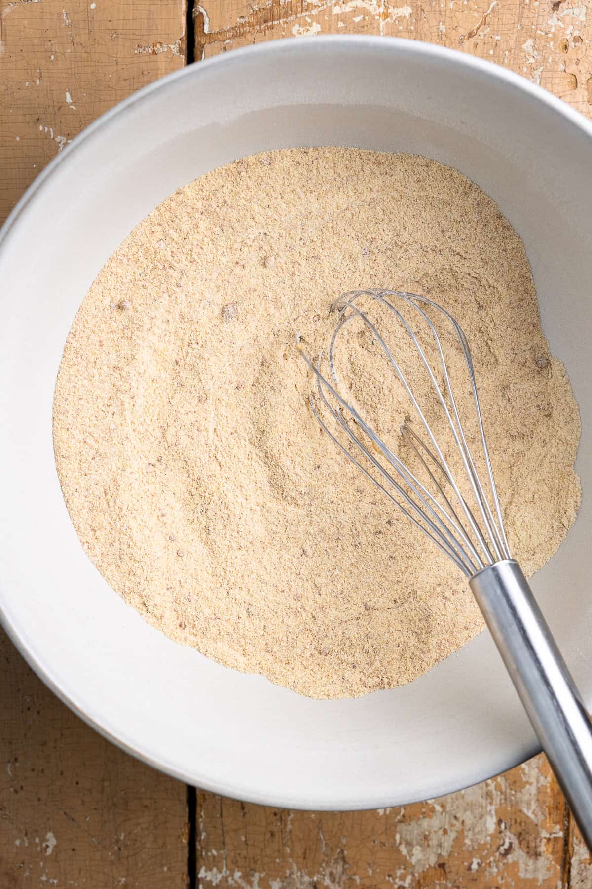 Fresh milled flour, sugar, baking powder, cinnamon, and salt mixed in a bowl.