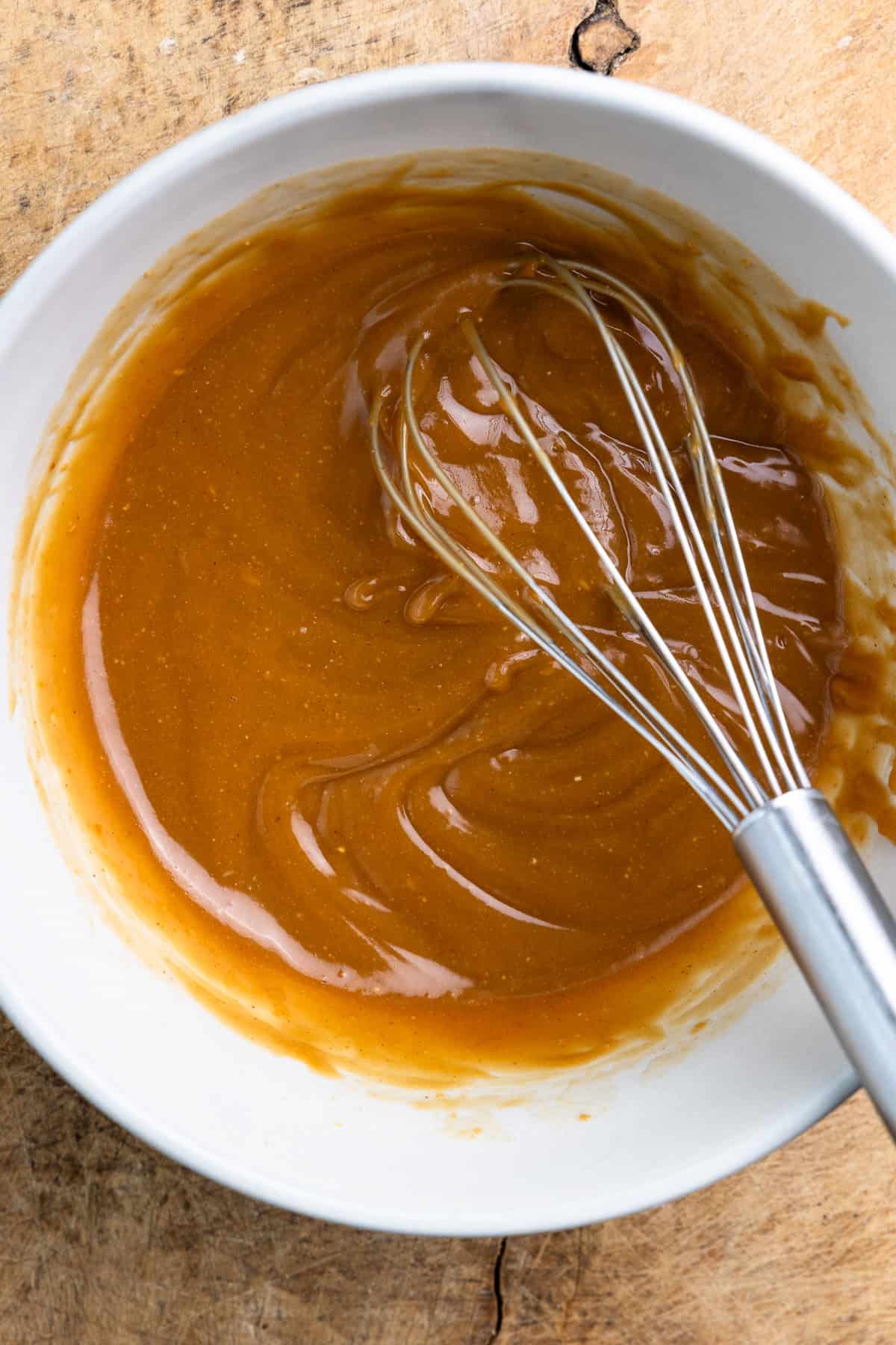 Peanut butter, maple syrup, coconut oil, sourdough discard and vanilla extract mixed in a bowl.