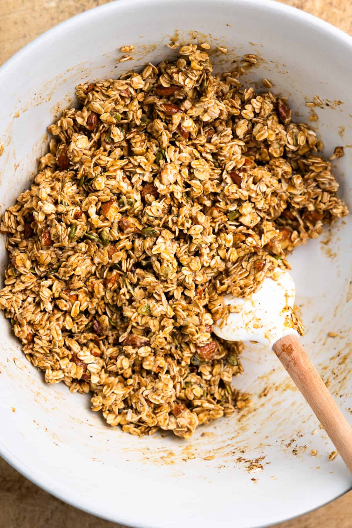 All dry and wet granola ingredients mixed in a bowl.
