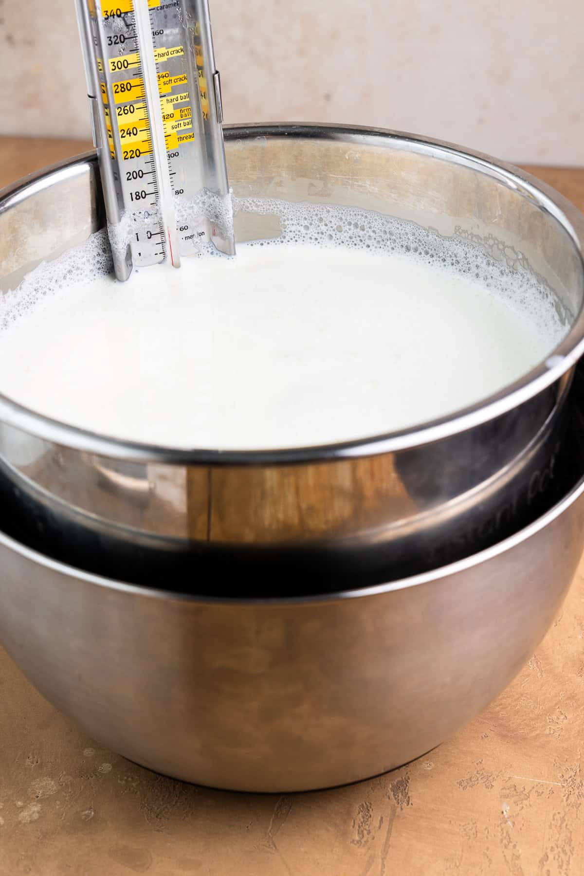 Instant Pot inner pot with milk inside sitting in a bowl of ice water.